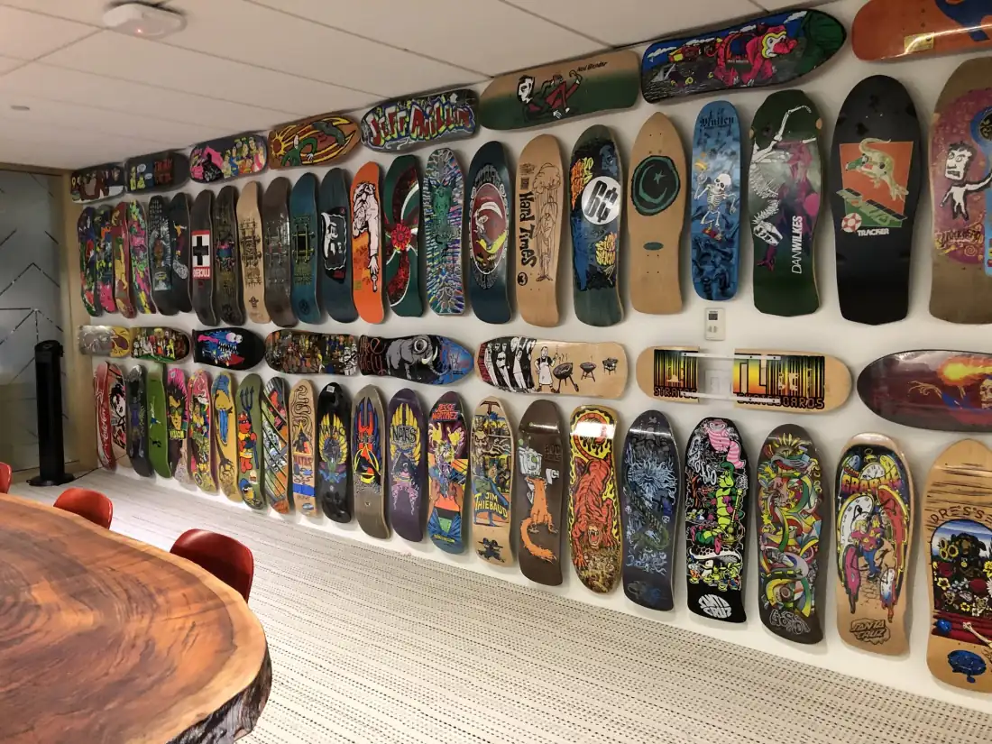 A wall in Mailchimp's board room covered floor-to-ceiling with vintage skateboard decks